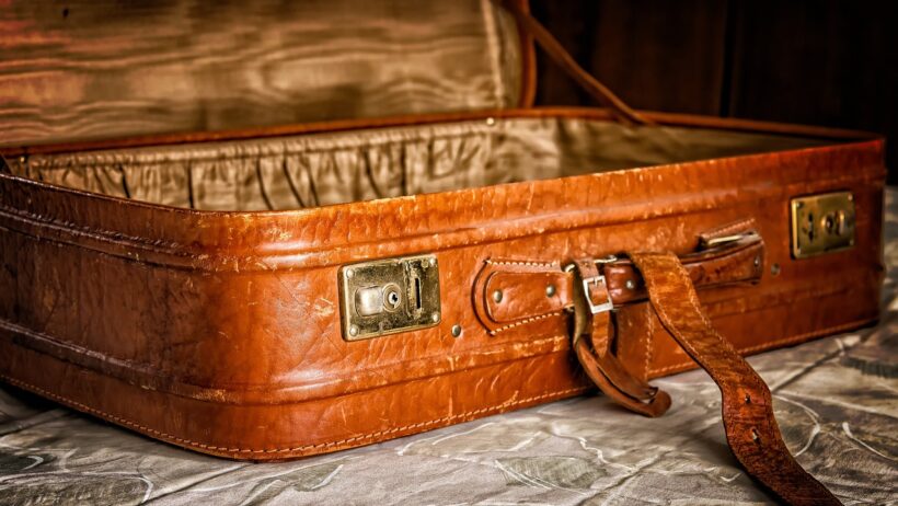 Suitcase packed with essential items for an Ayahuasca retreat, including natural fabrics, comfortable clothing, and personal items for a healing journey.